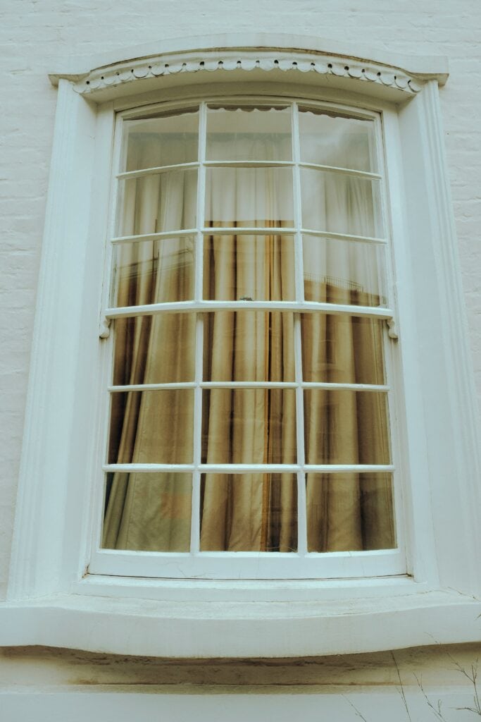 Arched window dressed with sheer curtains