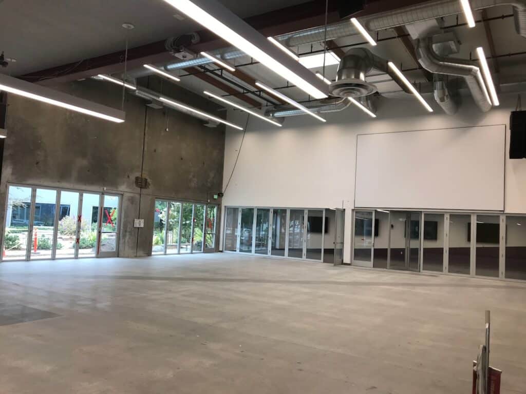 Bare commercial interior with concrete walls and new windows