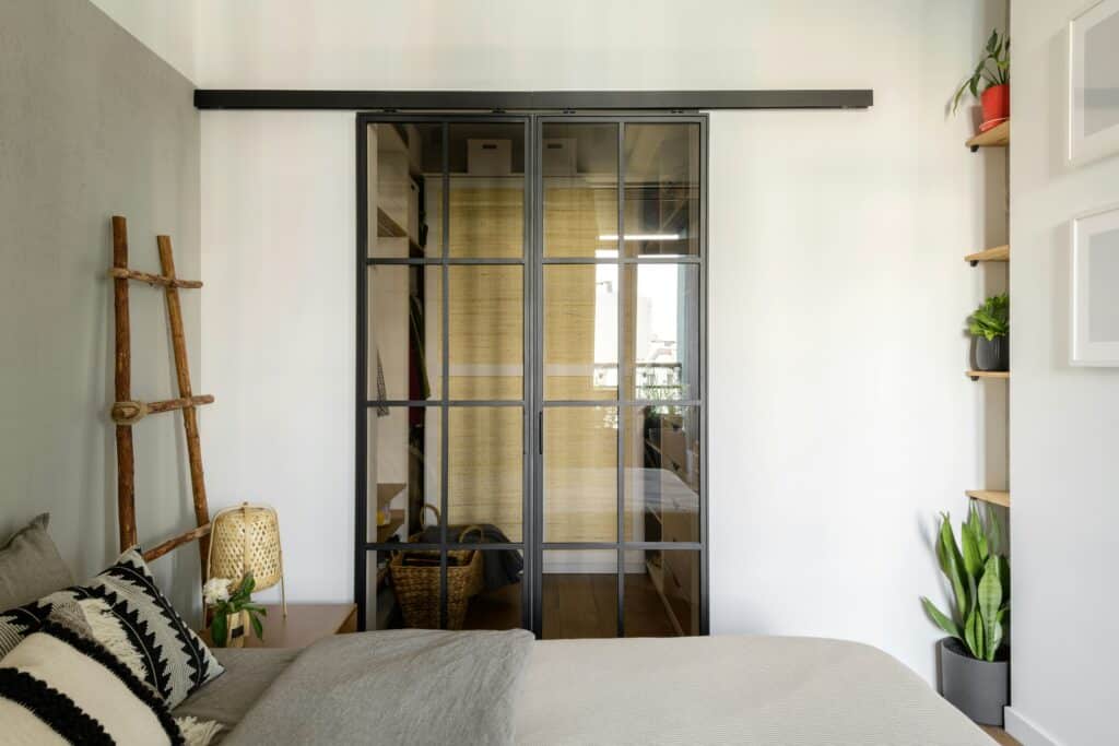 Bedroom with a black framed glazed partition