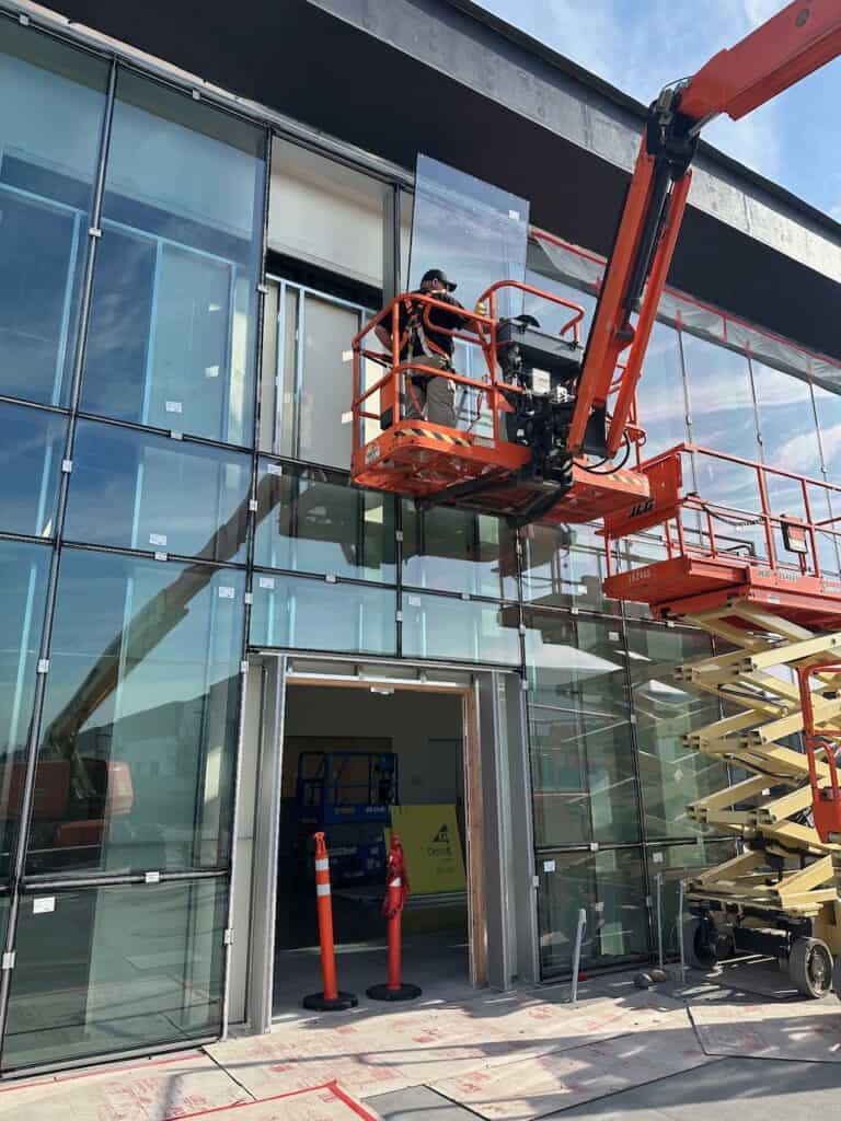 Boom lift working at a glazed building facade