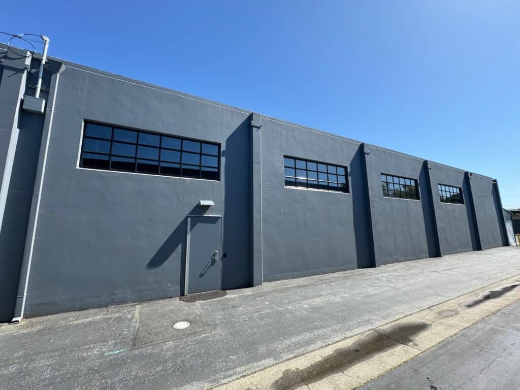 Multiple window bands installed along a long commercial building