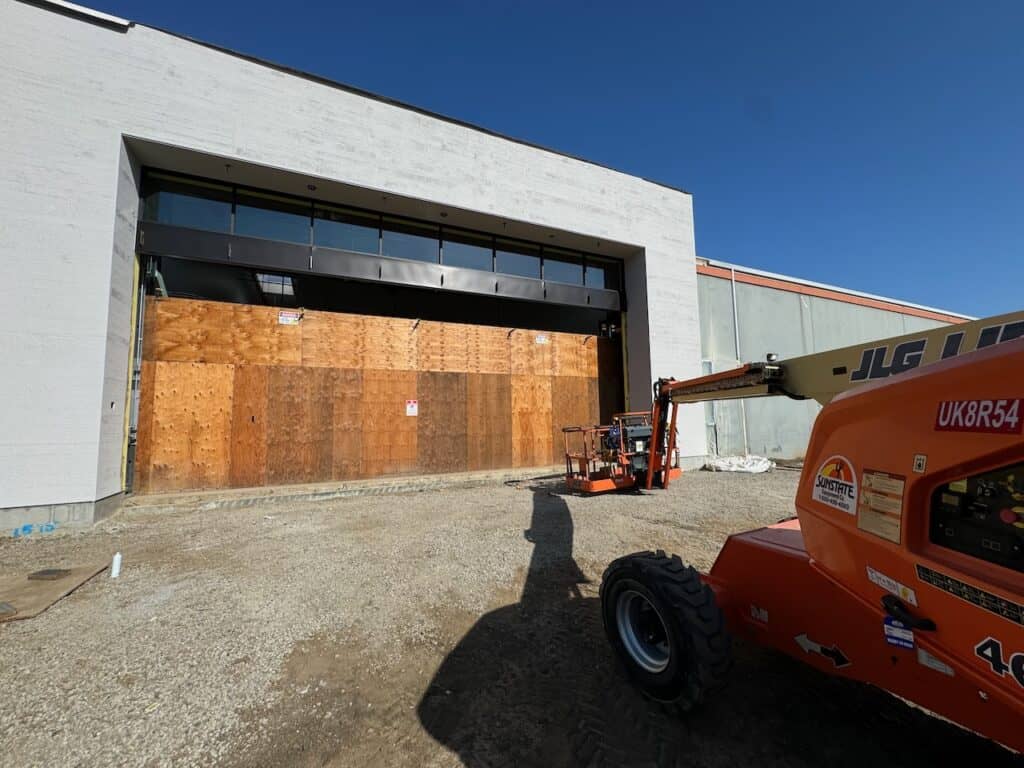 Commercial opening boarded with plywood ahead of new storefront glazing