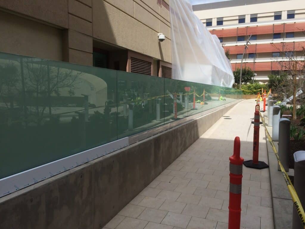 Completed glass balustrade along an exterior walkway
