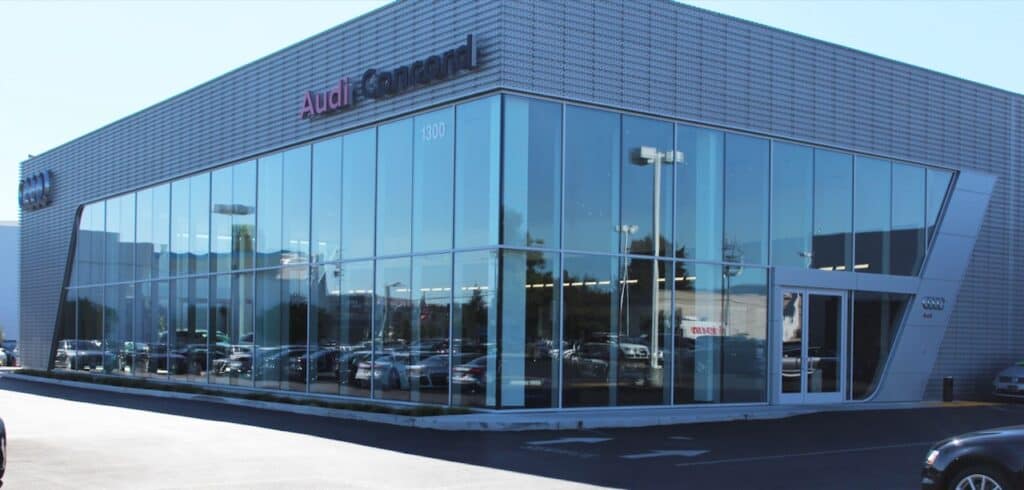 Corner curtain wall glazing on an Audi dealership building