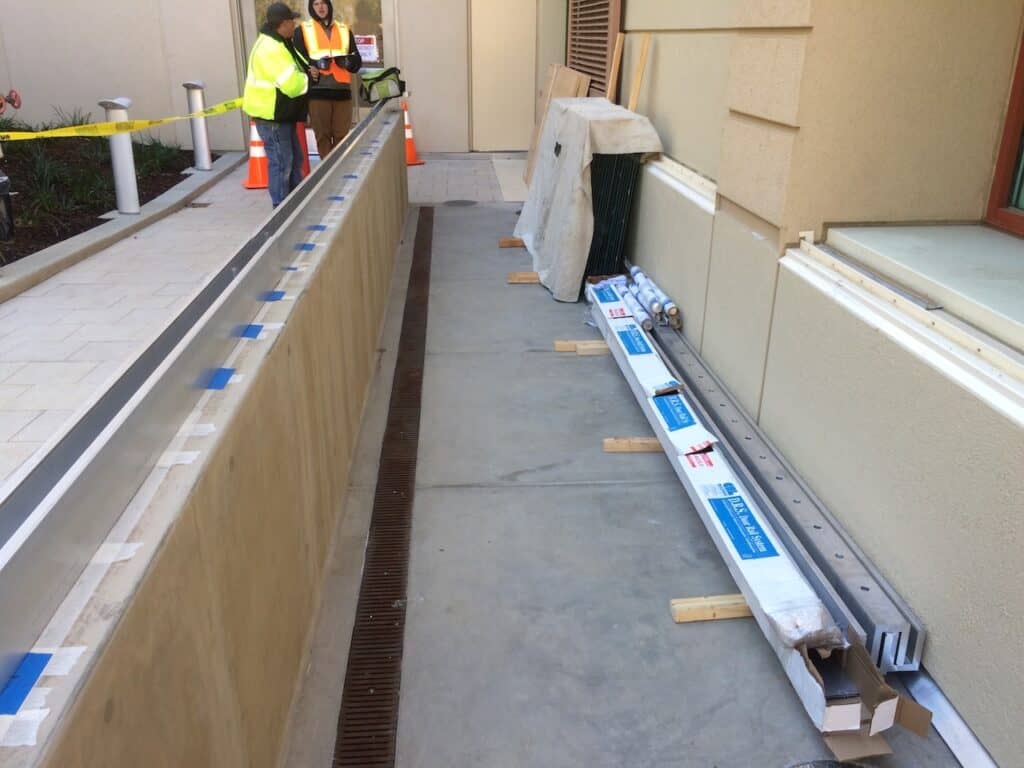 Glass balustrade panels being installed along a walkway