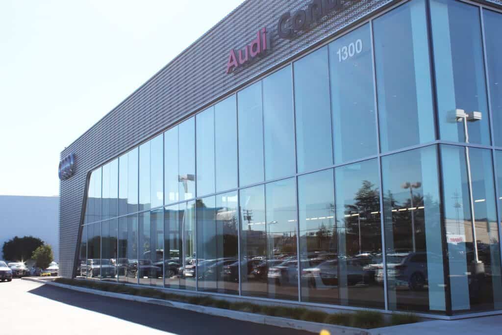 Glass curtain wall along the frontage of an Audi dealership