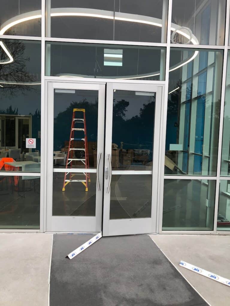 Glass doors with a ladder during installation