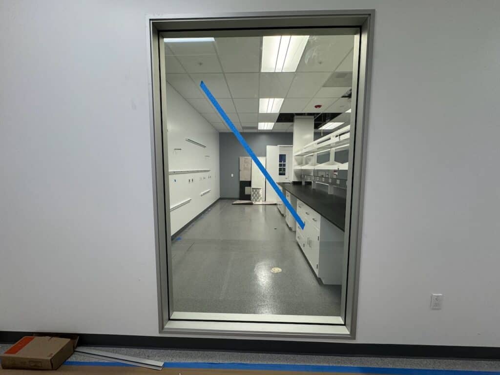 Glass partition door installed in an office corridor
