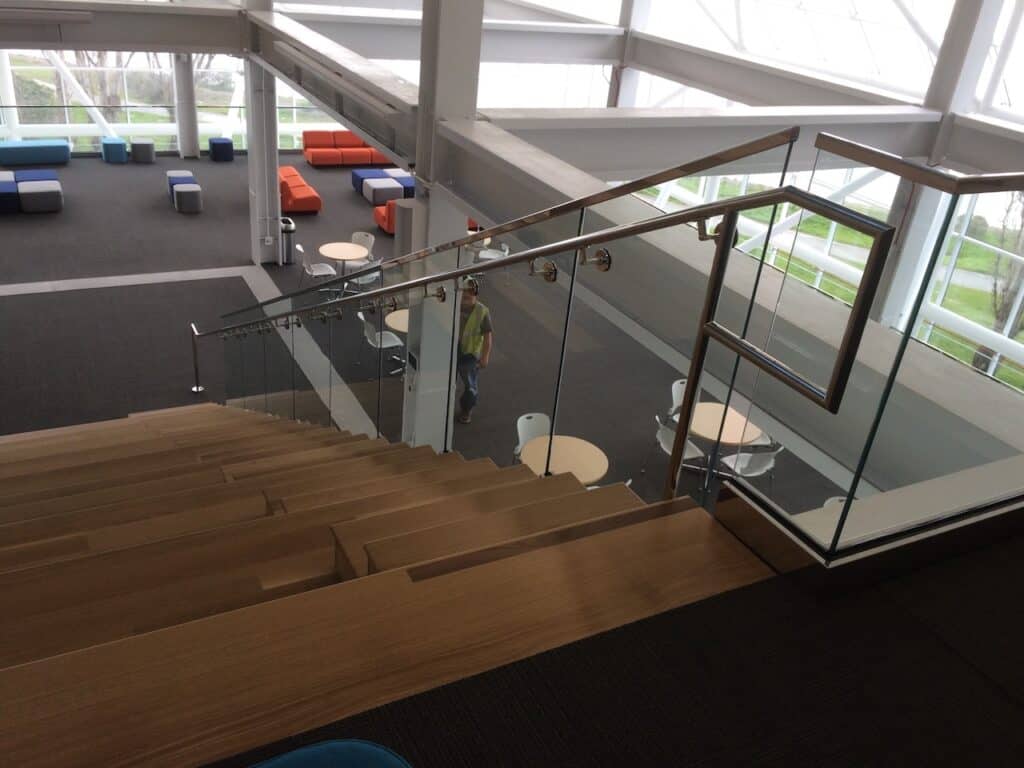 Glass stair railing viewed from an upper floor