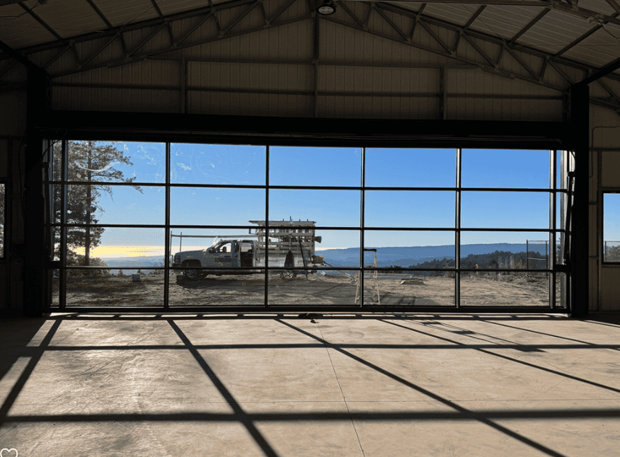 Glazed sectional door opening onto a yard