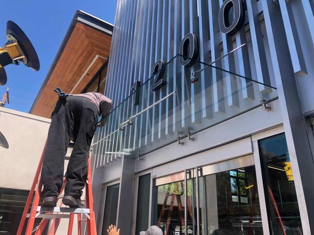 Glazier installing glass on a building exterior