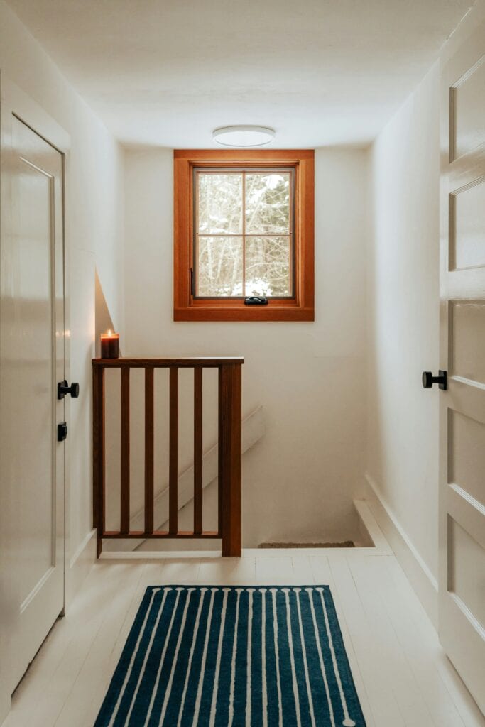 Hallway lit by a timber framed window