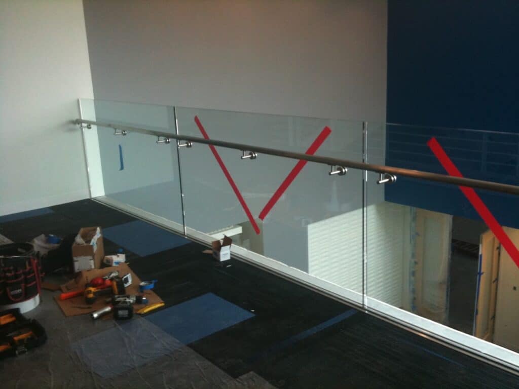 Interior glass partition marked with safety tape after installation