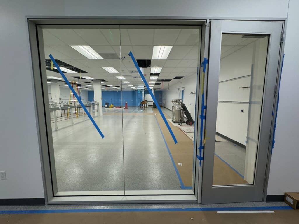Interior glass partition wall with a glass door in an office fit out