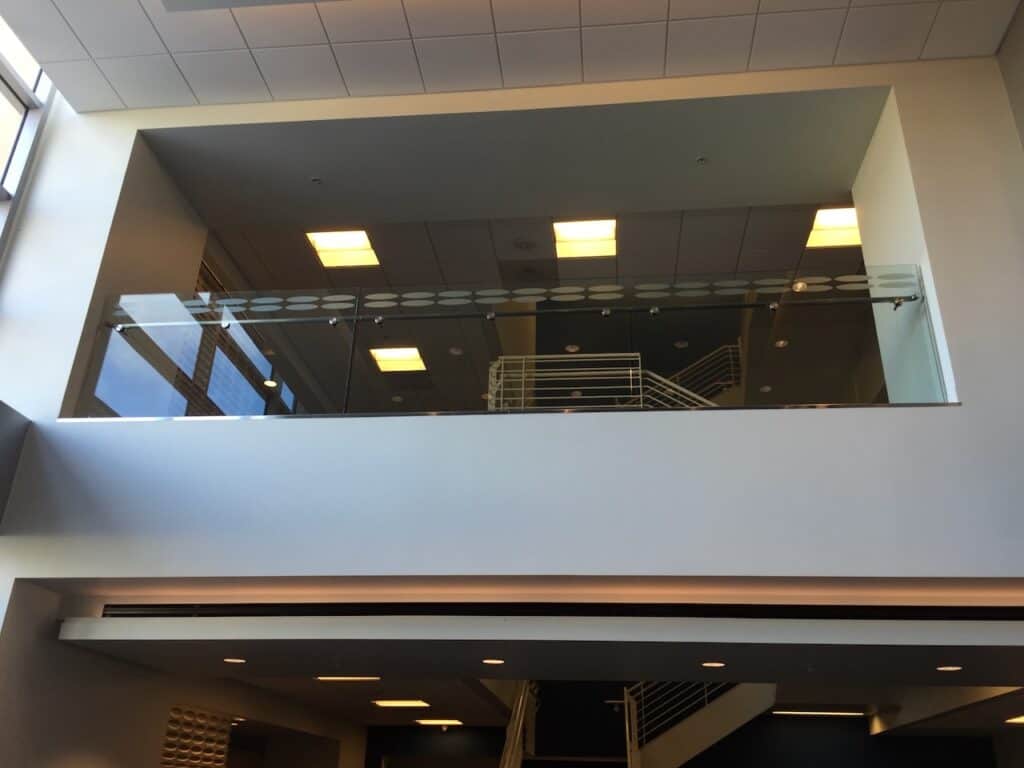 Interior glass railing along a mezzanine level