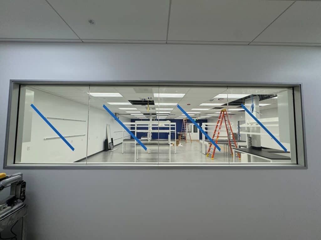 Interior glass window wall looking into a workspace
