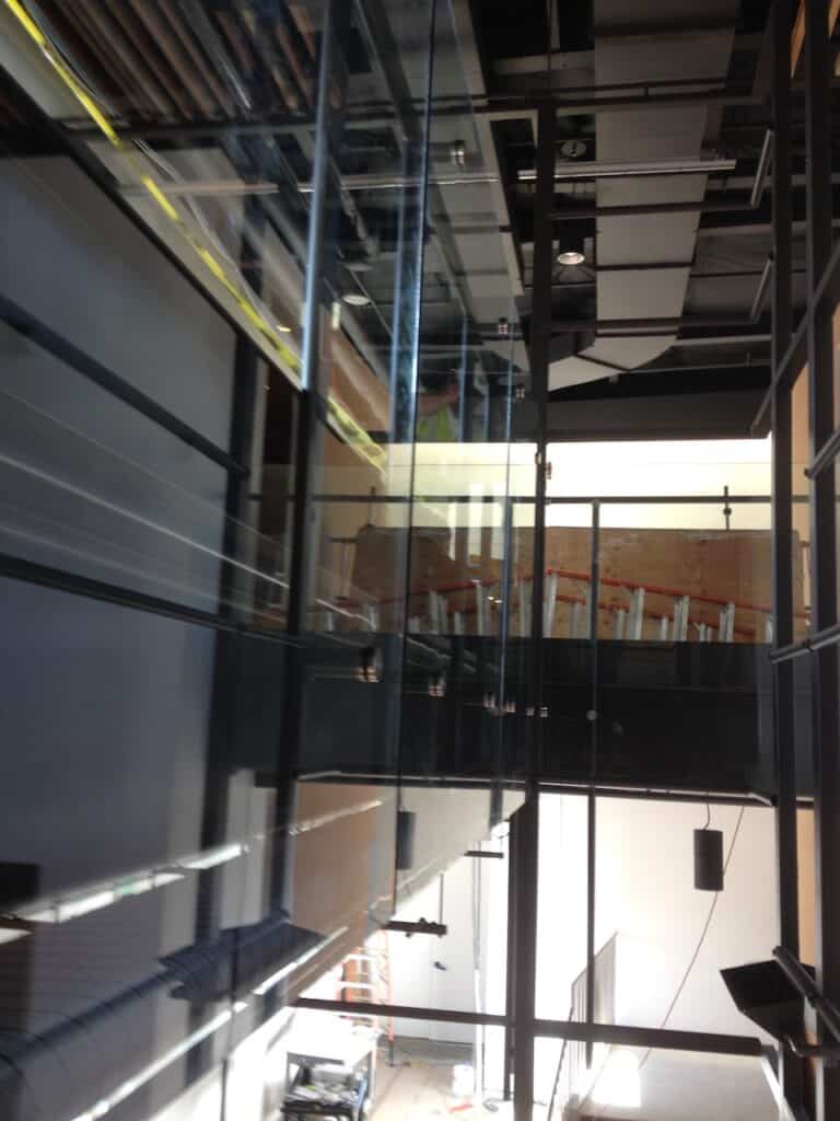 Interior glazed partition in a dark frame