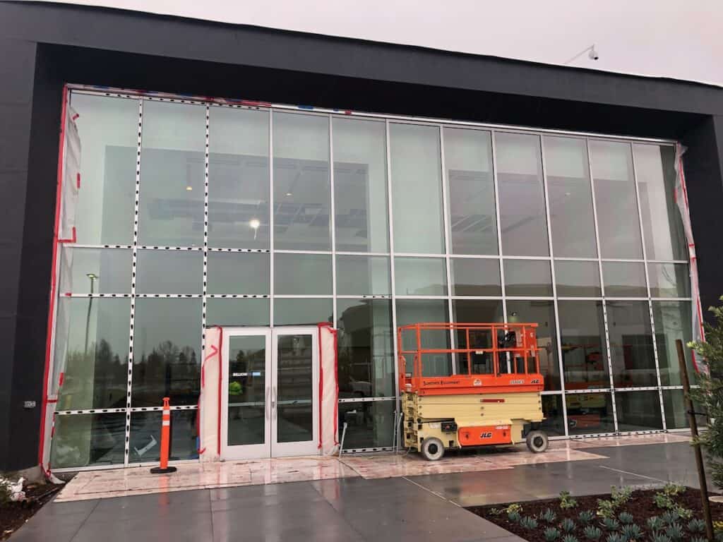 Large curtain wall with a scissor lift in front