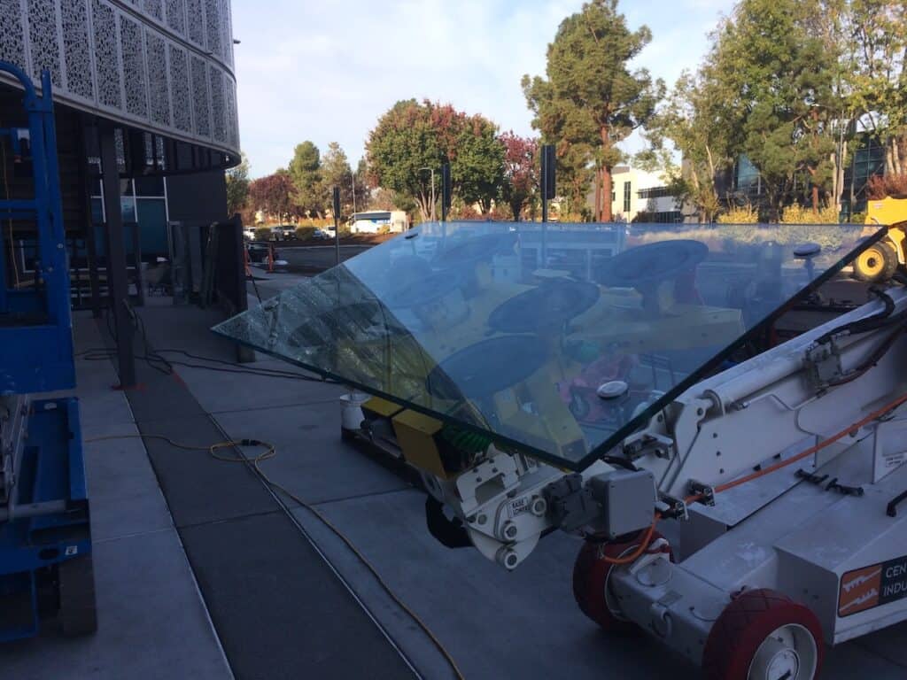 Large glass panel being handled on site before installation