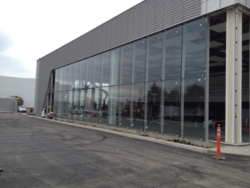 Long commercial building clad in dark glazed panels