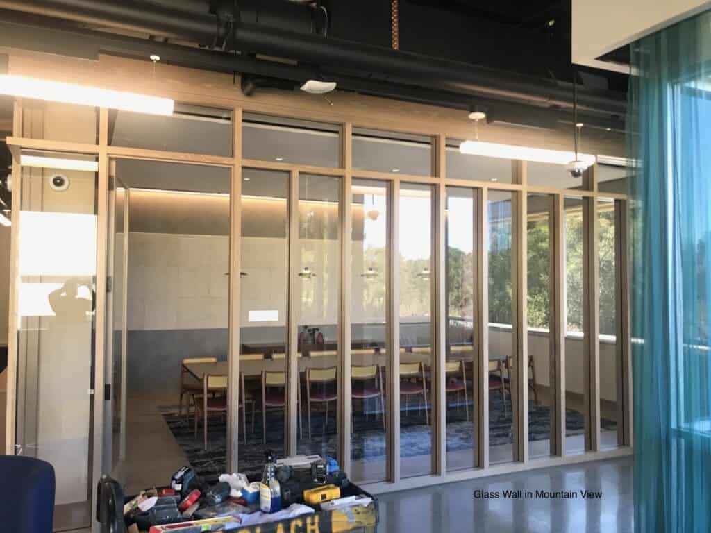Meeting room enclosed with floor to ceiling glass partitions