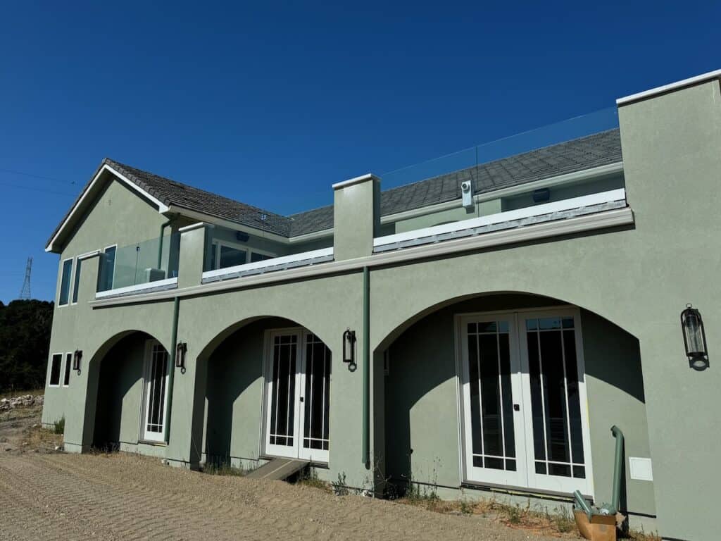 New windows installed across the arched facade of a multi unit residential building