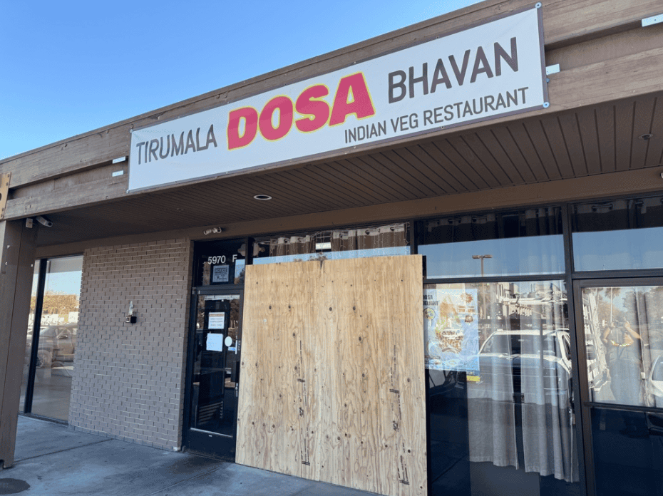 Restaurant frontage with a boarded panel awaiting glass replacement