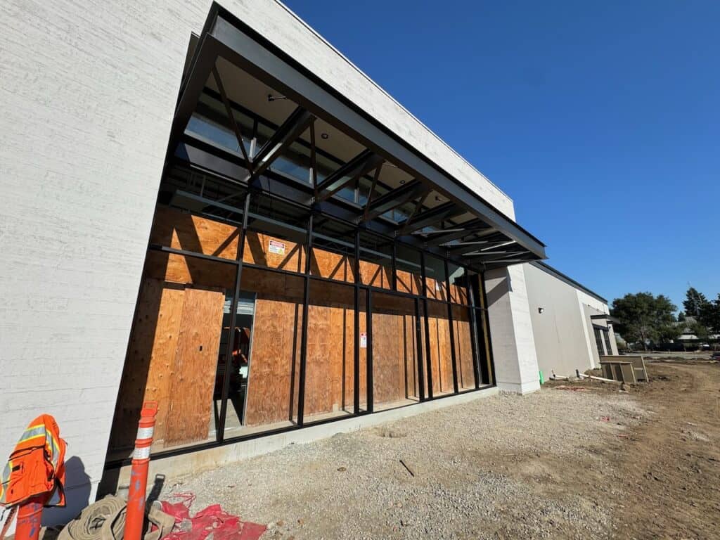Row of tall dark framed windows along a commercial building