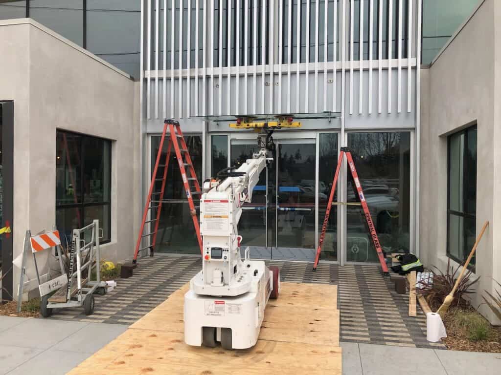 Storefront glazing being installed inside a commercial unit under construction