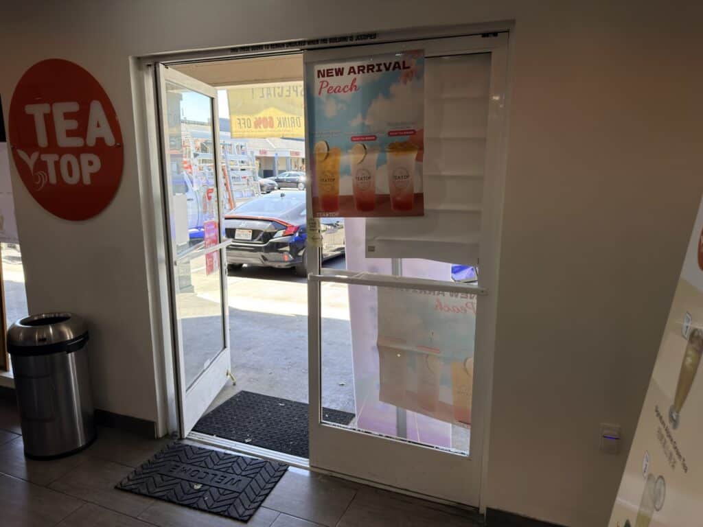 Tea shop interior behind newly installed glass entrance doors