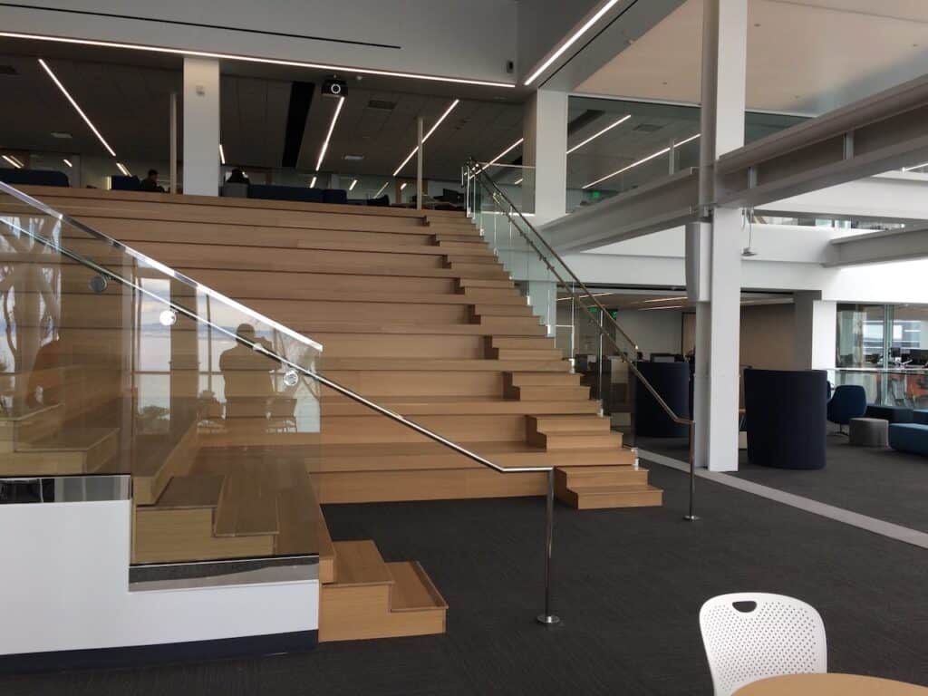 Timber staircase with a glass balustrade in an office