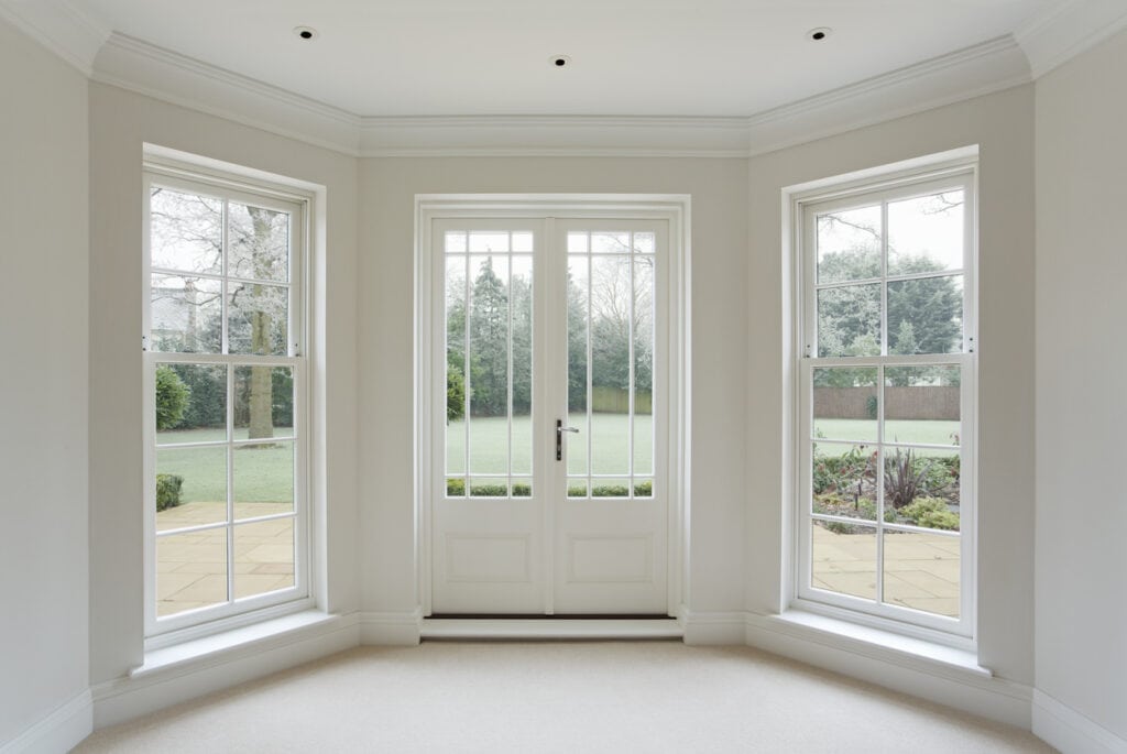 White French doors flanked by fixed window panels